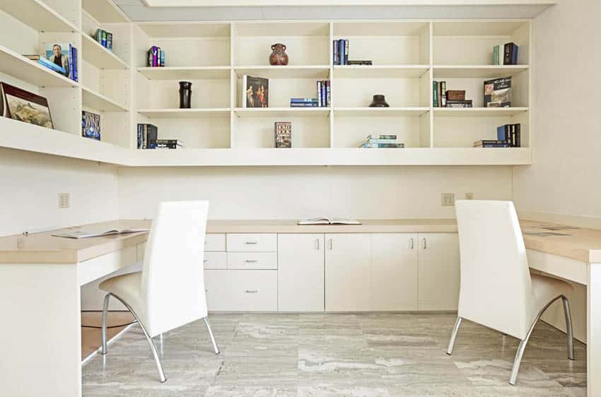Home office with dual built in desks shelving